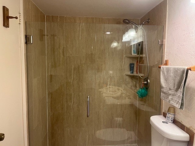 bathroom with walk in shower and toilet