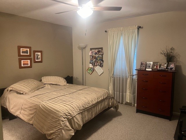 carpeted bedroom featuring ceiling fan