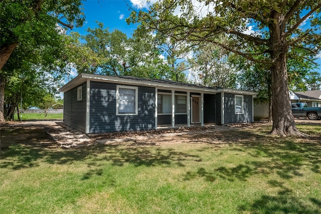 rear view of property featuring a yard