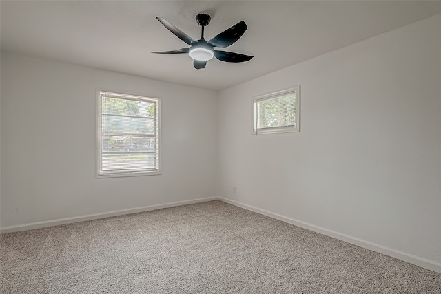 spare room with carpet floors, ceiling fan, and a wealth of natural light