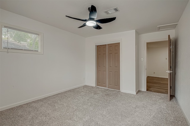 unfurnished bedroom featuring light carpet, a closet, and ceiling fan