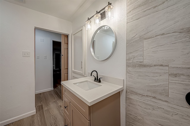 bathroom with vanity and hardwood / wood-style floors