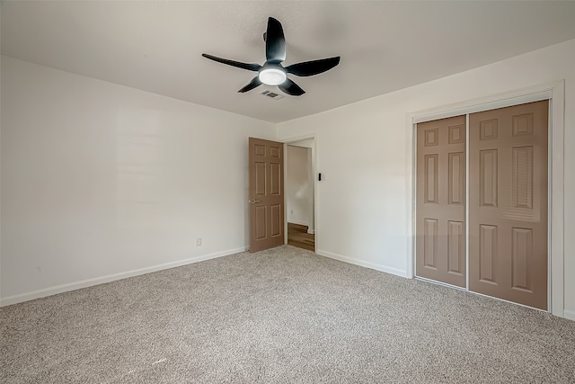 unfurnished bedroom with a closet, ceiling fan, and carpet floors