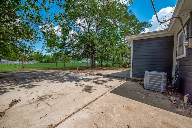 view of yard with central AC unit and a patio area