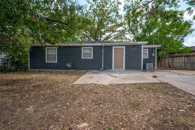 rear view of house with a patio and cooling unit