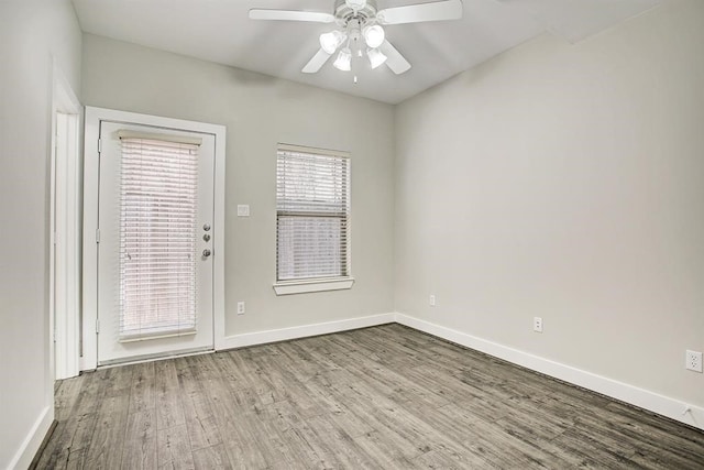 empty room with ceiling fan and light hardwood / wood-style floors