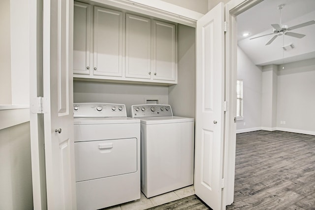 laundry room with cabinets, light hardwood / wood-style flooring, washer and dryer, and ceiling fan