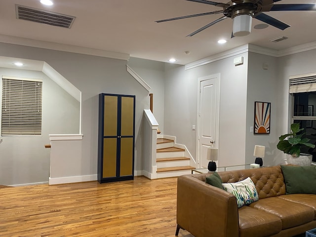 living room featuring light wood-type flooring and ornamental molding