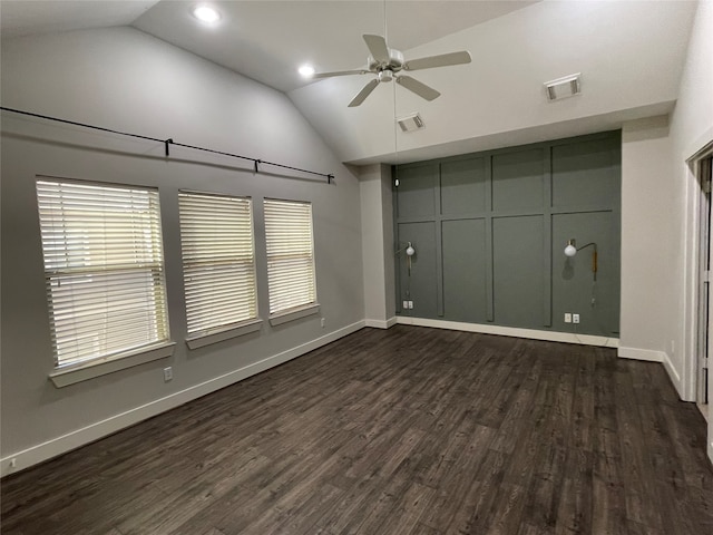 empty room featuring dark wood-type flooring, ceiling fan, and lofted ceiling