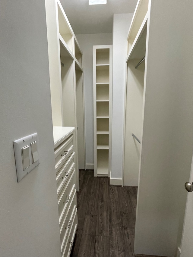 walk in closet with dark wood-type flooring