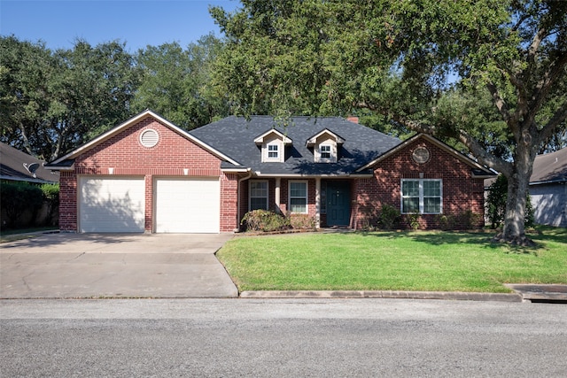 view of front of property with a front yard and a garage