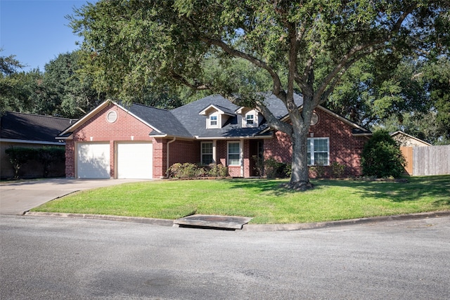 view of front of home with a garage and a front yard