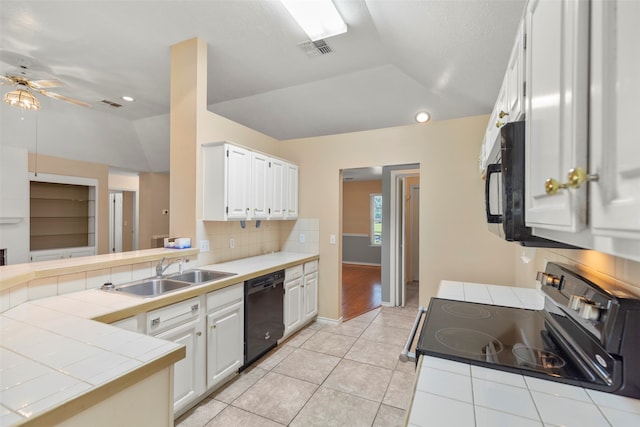 kitchen featuring sink, white cabinets, black appliances, tile countertops, and light tile patterned floors