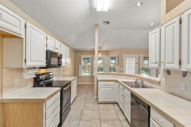 kitchen with white cabinets, tile countertops, sink, and black appliances