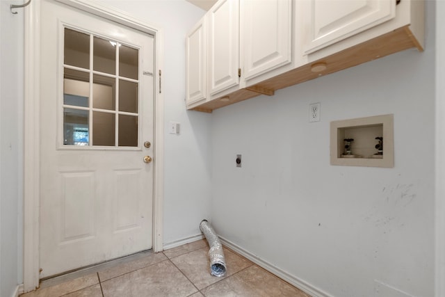 laundry room featuring hookup for a washing machine, hookup for an electric dryer, light tile patterned floors, and cabinets