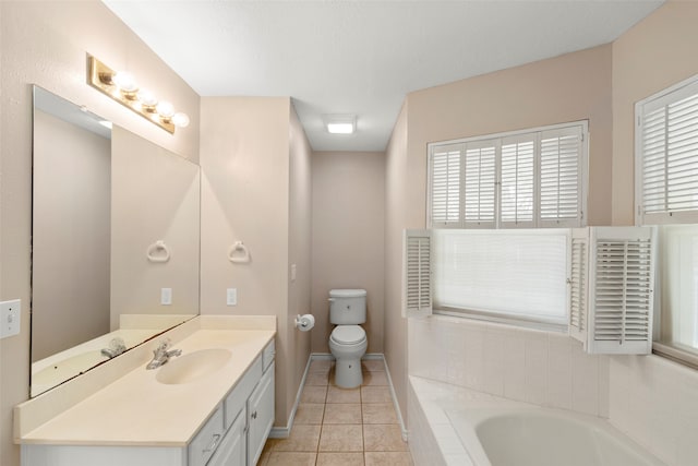 bathroom featuring tile patterned floors, tiled bath, vanity, and toilet