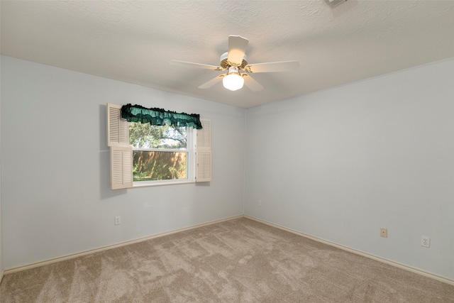 carpeted empty room with a textured ceiling and ceiling fan