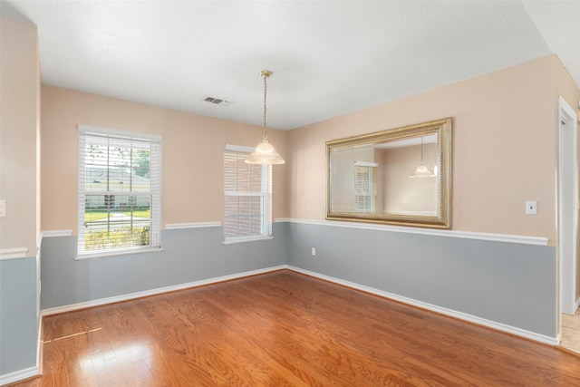 unfurnished room with wood-type flooring