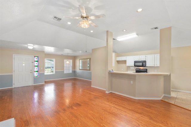 unfurnished living room featuring ceiling fan, lofted ceiling, and light hardwood / wood-style floors