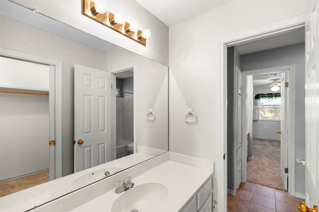 bathroom featuring tile patterned flooring, vanity, and toilet