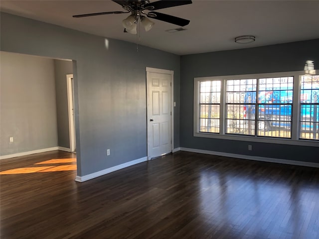 empty room featuring ceiling fan and dark wood-type flooring