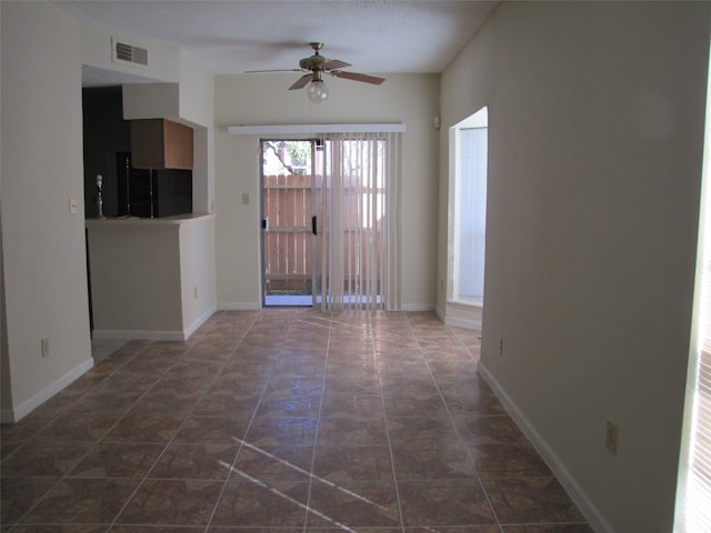 entryway featuring ceiling fan and a textured ceiling