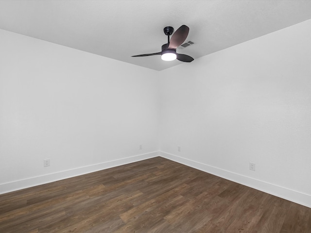 empty room featuring ceiling fan and dark hardwood / wood-style flooring