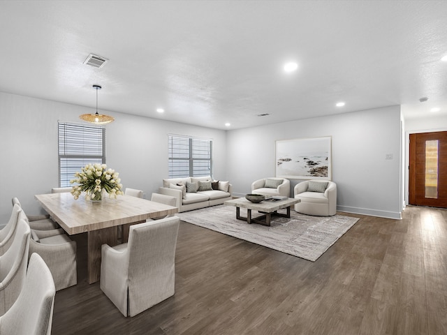 living room featuring a textured ceiling and dark hardwood / wood-style flooring