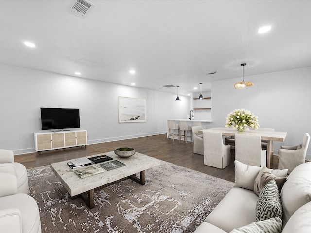 living room with dark wood-type flooring and sink