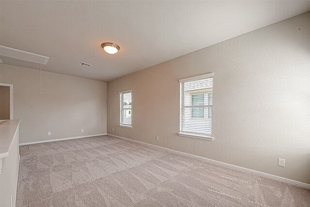 empty room featuring light colored carpet