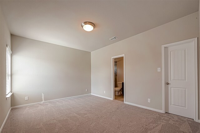 unfurnished room featuring light carpet