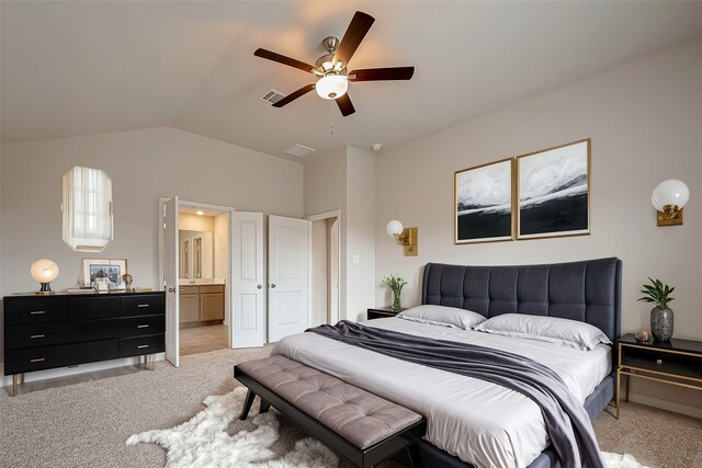 carpeted bedroom featuring lofted ceiling, ceiling fan, and connected bathroom