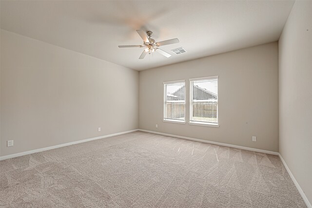 carpeted empty room featuring ceiling fan