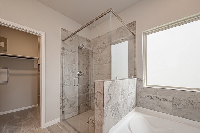 bathroom featuring hardwood / wood-style floors and separate shower and tub