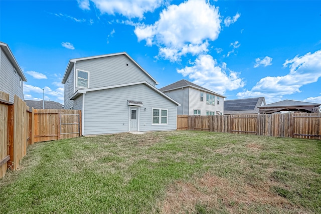 rear view of property with a yard