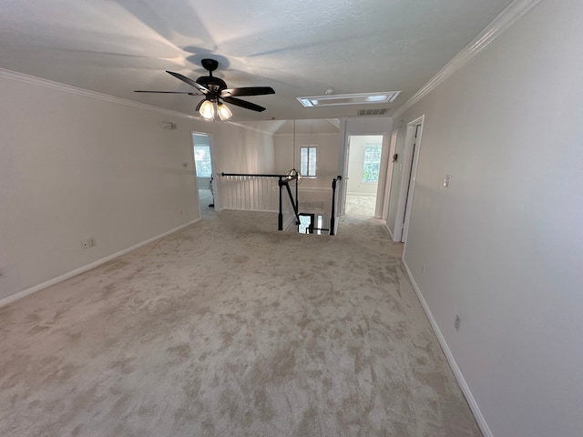 carpeted empty room with ceiling fan and crown molding