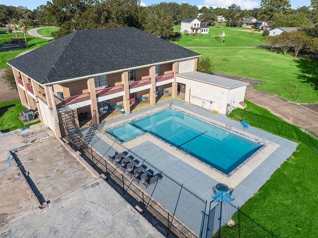 view of pool with a jacuzzi, a lawn, and a patio area