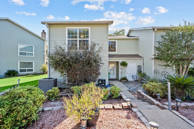 view of front of property featuring cooling unit and a patio