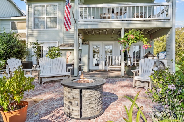 view of patio / terrace with an outdoor fire pit and french doors