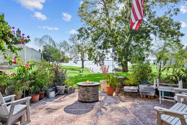 view of patio / terrace with a water view and an outdoor fire pit