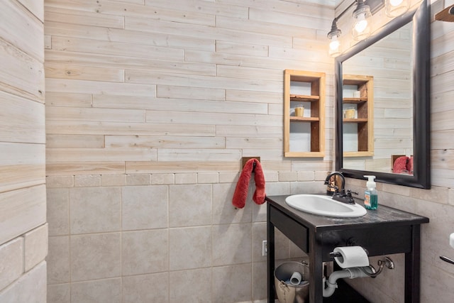 bathroom with wood walls and vanity