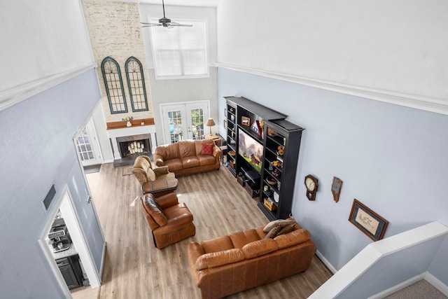 living room with wood-type flooring, french doors, a high ceiling, and ceiling fan