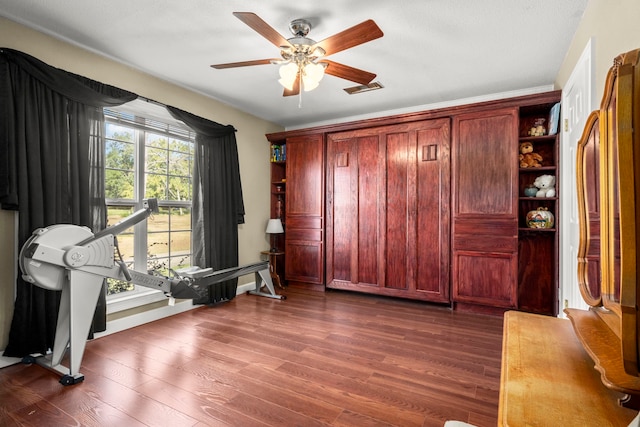 interior space featuring ceiling fan and dark wood-type flooring