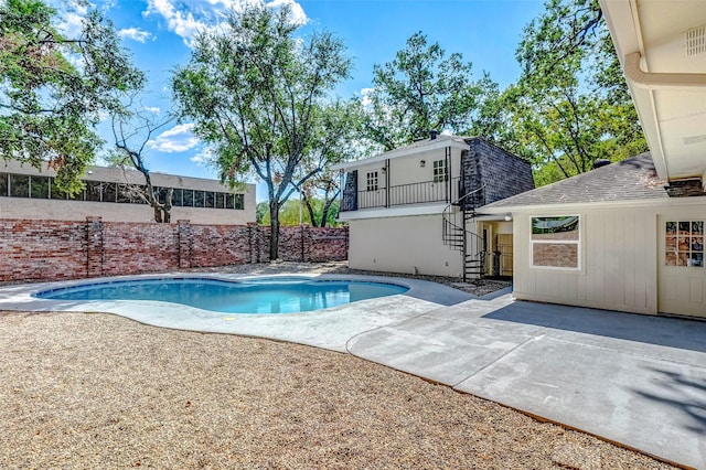 view of swimming pool with a patio area