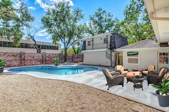 view of pool featuring an outdoor living space and a patio