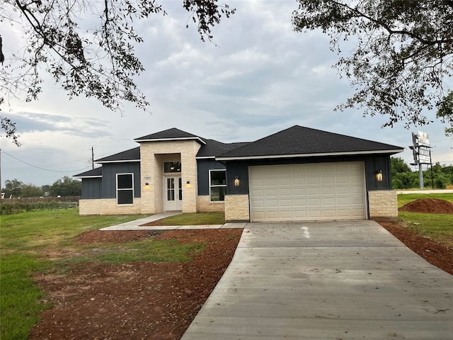 view of front facade with a front yard and a garage