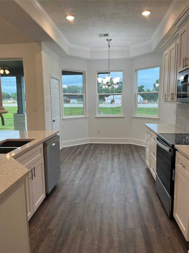 kitchen with crown molding, sink, pendant lighting, appliances with stainless steel finishes, and dark hardwood / wood-style flooring