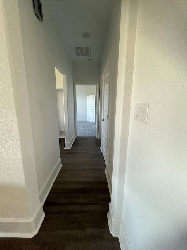 corridor with dark wood-type flooring