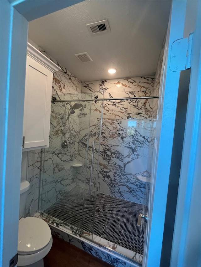 bathroom with toilet and walk in shower