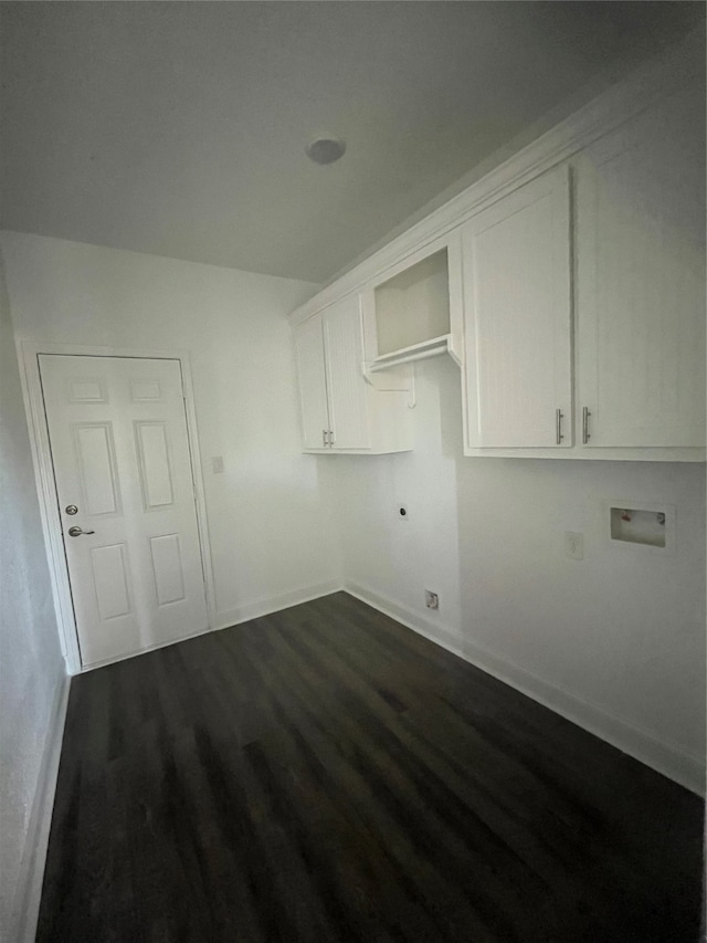 washroom featuring electric dryer hookup, hookup for a washing machine, dark hardwood / wood-style floors, and cabinets